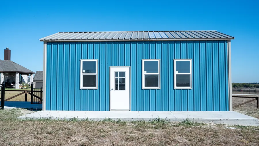 Blue steel carport installed on a residential property